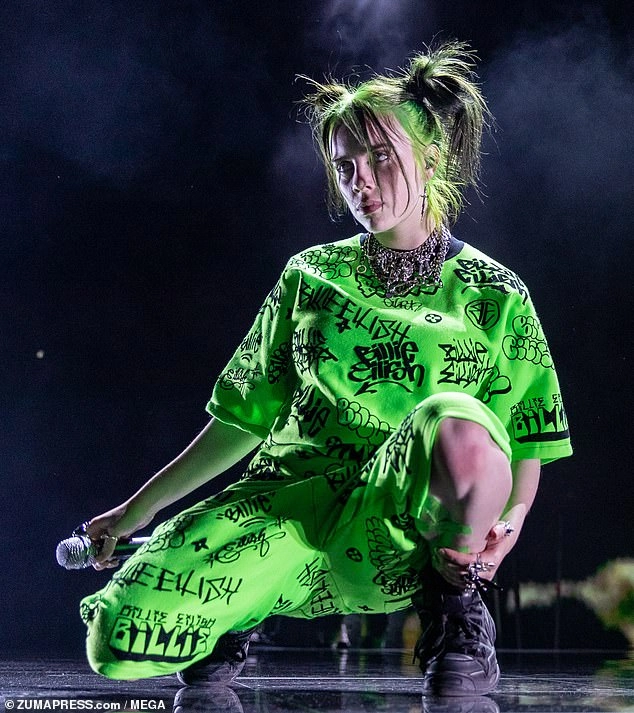 Billie Eilish makes the rare move of showing off her chest in a low-cut tank top for Gucci... after admitting she has had body insecurities all her life